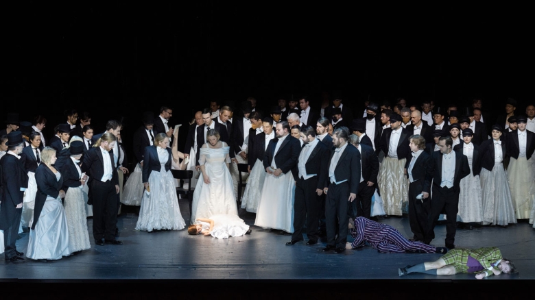 Masters, Claudia Mahnke (Magdalena, in white) & chorus with Michael Nagy (Beckmesser, in pyjamas) & Michael Porter (David) lying on the floor